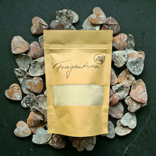 Lade das Bild in den Galerie-Viewer, Ein brauner Kraftpapierbeutel mit Sichtfenster und Fragantura-Logo, gefüllt mit naturbelassener Schafwolle, liegt auf einem Untergrund aus herzförmig geschnittenem Holz in verschiedenen Brauntönen